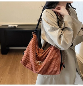 Detailed side view of a large plaid tote bag with FASHION print and rope strap