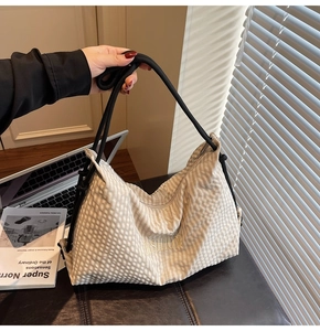 Detail of cream plaid canvas tote bag with yellow Fashion embroidery and black rope handle
