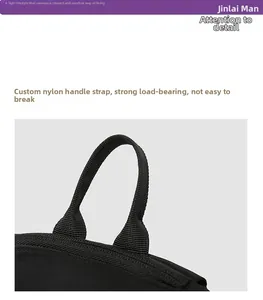 Close-up of durable reinforced nylon handle on black backpack for high weight capacity