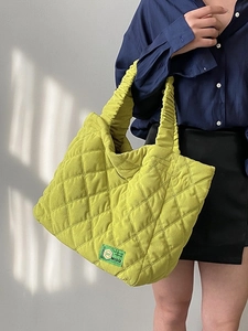 Bright lime green quilted tote bag with diamond stitching and ruffled handle design