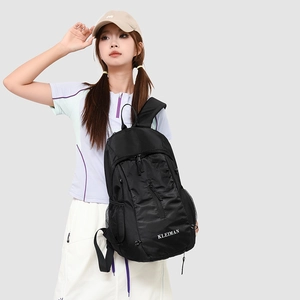 Detail of black sports backpack showing honeycomb mesh texture and KLEIMAN logo design