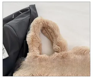 Detail of soft plush tote bag featuring a wide comfortable shoulder strap in light brown