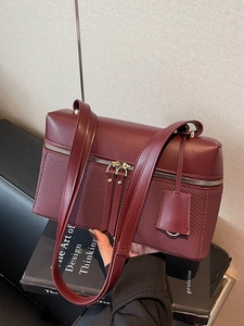 Deep red leather and woven tote bag with dual zippers and matching shoulder strap