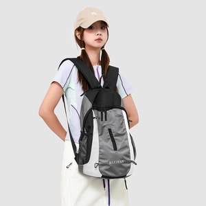 Close-up of lightweight grey and black sports backpack with multiple zipper compartments