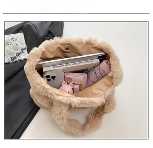 Spacious interior of beige faux fur tote bag showing storage for tablet and essentials