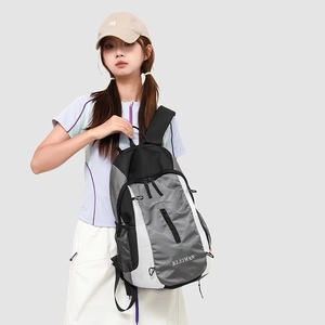 Detail of grey diamond-patterned fabric and side mesh pocket on an outdoor backpack