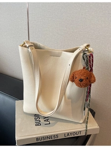 Minimalist cream white large capacity bucket bag with teddy bear charm and braided strap