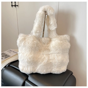 Detailed close-up of large white plush faux fur tote bag with soft shoulder strap handle