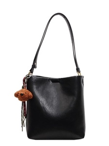 Minimalist black bucket shoulder bag with adjustable strap and cute teddy bear charm