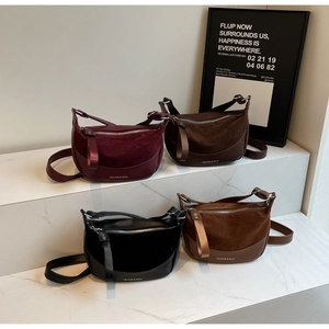 Detail of multi-color crescent saddle bags with matte finish and fashion lettering