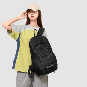 Close-up of black crossbody sports bag with mesh panel and adjustable side zipper pocket