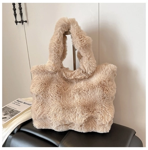 Close-up of soft beige faux fur texture on a large capacity plush tote bag