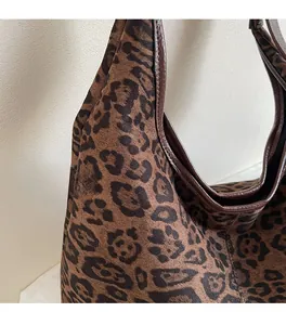 Detail of soft leopard print fabric texture and dark piping on this vintage tote bag