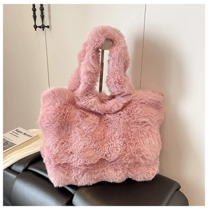 Close-up of the soft pink faux fur texture and sturdy handle of the winter tote bag