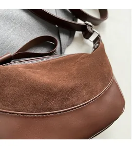 Detail of dark brown dumpling bag showing suede and smooth leather texture contrast