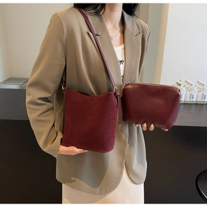 Detail of burgundy frosted bucket bag and matching leather pouch for elegant styling