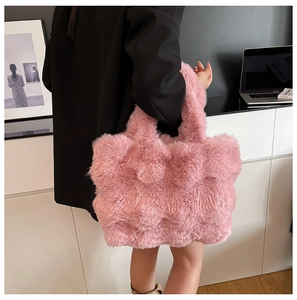 Detail of pink faux fur tote bag with textured grid pattern and soft shoulder strap