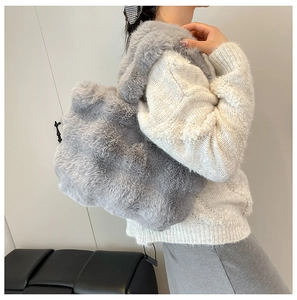 Model wearing a grey faux fur tote bag showing the soft texture and large capacity