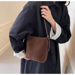 Close-up of brown matte suede bucket bag with Fashion & Bags embossed lettering