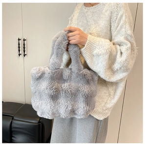 Close-up of soft grey faux fur tote bag showing the fluffy texture and plush handle