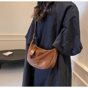 Detail of hobo shoulder bag with matte brown leather and suede stitching texture