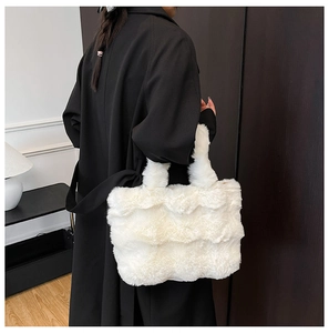 Detailed texture of white plush tote bag with wavy faux fur on a black winter coat
