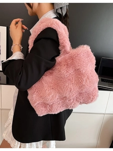 Pink fluffy faux fur tote bag with large capacity and plush texture shown on model
