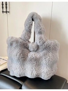 Fuzzy grey faux fur tote bag with plush pom-pom decor for winter season fashion