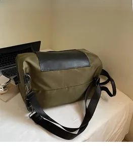 Olive green travel backpack featuring a wide adjustable strap and sleek black leather lid