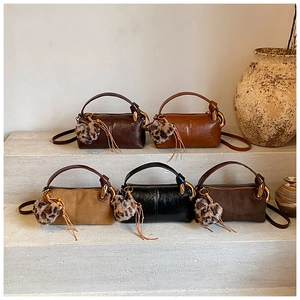 Collection of retro mini cylinder bags in various earth tones with leopard heart charms