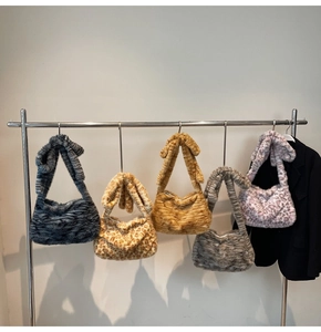 Detail of soft plush tote bags with various animal prints and bow shoulder strap accents