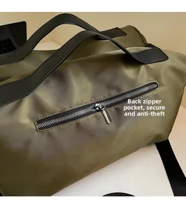 Detailed view of the olive green travel bag showing back anti-theft zipper pocket