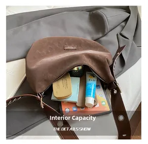 Detailed interior view showing large capacity of this brown vintage crescent tote bag