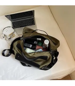 Top-down view of a spacious army green canvas travel bag with laptop and accessories