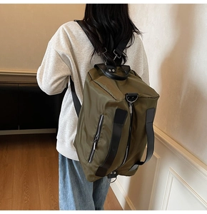 Olive green travel backpack shown on person highlighting large capacity and comfort