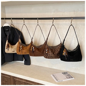 Collection of hobo shoulder bags in suede textures with decorative wooden beads