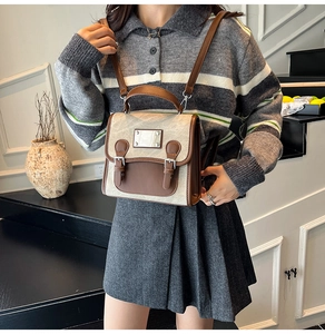 Detail of vintage canvas and faux leather backpack with metallic buckle on a model