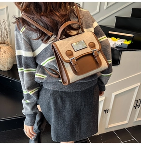 Vintage denim backpack with brown leather trim shown on model in stairwell