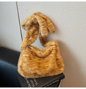 Detailed view of orange tiger stripe faux fur texture on a plush autumn tote bag