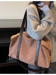 Large caramel canvas tote bag with brown leather straps shown on a model for daily commute