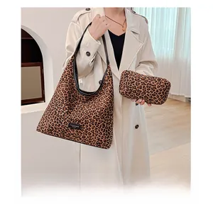 Detailed view of leopard print tote bag set with matching zipper pouch and black handles
