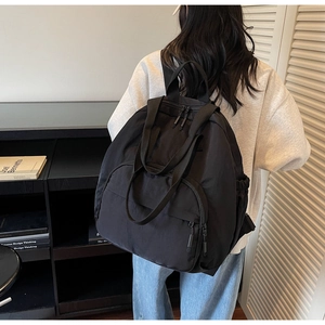 Black versatile nylon tote backpack with adjustable straps shown in a lifestyle home setting