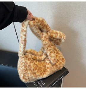 Detailed view of plush leopard print tote bag with soft faux fur texture and top handle