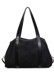 Large black canvas tote bag with leather handles and top zipper for daily use
