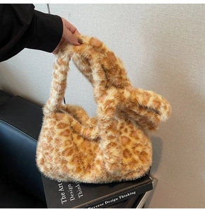Close-up of fluffy leopard print plush texture and soft handle on the autumn tote bag