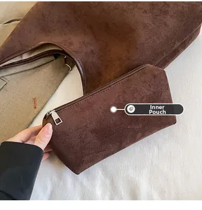 Close-up of the functional inner zipper pouch inside the brown suede tote bag