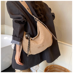 Chic light khaki hobo bag with braided rope and metal eyelets on shoulder strap