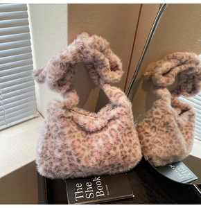 Close-up of pink leopard print plush tote bag with soft faux fur texture and sturdy handle
