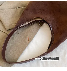 Detail of comfortable handle and vintage brown suede texture on this tote bag