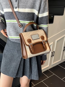 Vintage拼接denim style shoulder bag with leather accents and adjustable straps worn by model